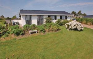 a house on a hill with a green yard at 2 Bedroom Lovely Home In Hejls in Hejls