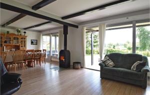 a living room with a couch and a wood stove at Holiday Home Pøt Strandby Juelsminde Ix in Sønderby +11 photos