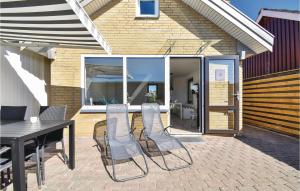 a patio with a table and chairs on a patio at One-Bedroom Holiday Home In Otterup in Otterup +12 photos