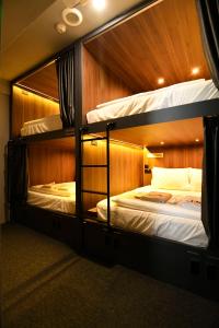 two bunk beds are in a room with at Wink at McCallum Street in Singapore