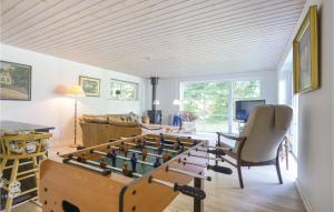 a living room with a foosball game on a table at 2 Bedroom Cozy Home In Ebeltoft in Øksenmølle +13 photos