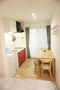 a small kitchen and dining room with a table at Sakura Shigure Shin-Osaka in Osaka