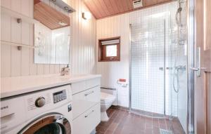 a bathroom with a washer and dryer in it at Holiday Home Nexø 14 in Vester Sømarken