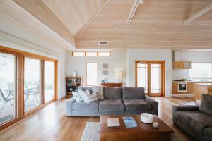 a living room with a couch and a table at Yallingup Villas in Yallingup