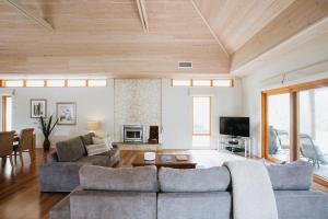 a living room with two couches and a tv at Yallingup Villas in Yallingup