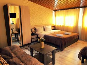 Habitación de hotel con cama y sofá en Bonus Hotel, en Tiflis