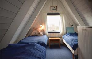 a bedroom with two beds and a window at Two-Bedroom Holiday Home In Knebel in Knebel +10 photos