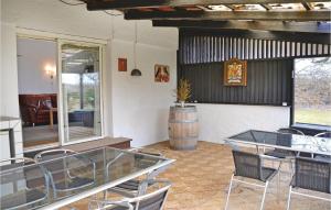 a room with a table and chairs and a barrel at Holiday Home Ellevej in Karlstrup Strand