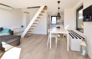 a kitchen and living room with a white table and stairs at Nice Home In Otterup With 1 Bedrooms And Wifi in Otterup