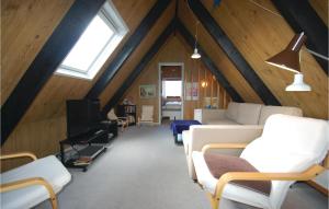 a living room with white furniture in a attic at Holiday Home Brombærvænget Humble Vi in Humble