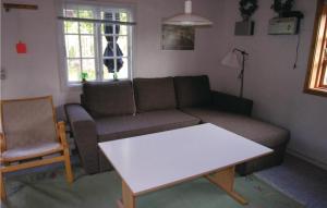 a living room with a couch and a table at Stunning Apartment In Allinge With Wifi in Allinge