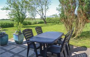 a blue table and chairs on a patio at Holiday Home Outrup I in Vester Debel
