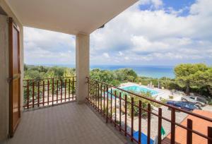 a balcony with a view of a pool and the ocean at Agriturismo Nardini in Rodi Garganico