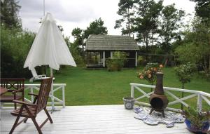 a deck with a table and chairs and an umbrella at Cozy Home In Otterup With Wifi in Otterup