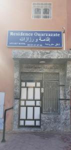 a building with a door with a sign on it at RESIDENCE OUARZAZATE in Ouarzazate