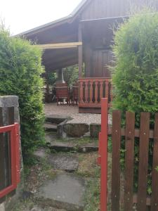 a house with a wooden fence and a patio at Chaloupka v Českém ráji in Rytířova Lhota