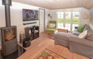 sala de estar con sofá y chimenea en Cozy Home In Nyborg With Kitchen en Nyborg