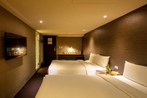 Postel nebo postele na pokoji v ubytování Goodmore Hotel
