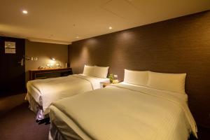 Postel nebo postele na pokoji v ubytování Goodmore Hotel