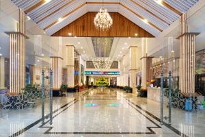 a large lobby with a chandelier in a building at LADALAT Hotel in Da Lat