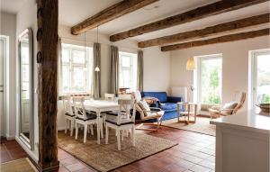 a kitchen and dining room with a table and chairs at Cozy Home In Gammelby With Sauna in Gammelby