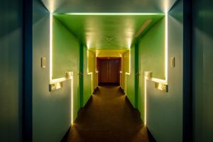 a hallway with green walls and a long corridor at Goodmore Hotel in Taipei