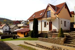 a white house with a brown roof at Vila Dravce in Dravce