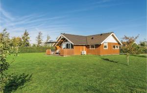 a house in a yard with a green lawn at Three-Bedroom Holiday Home In Sydals in Skovbyballe