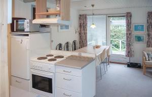 a kitchen with a stove and a counter top at 2 Bedroom Nice Home In Hejls in Hejls