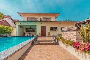 a home with a swimming pool and a house at VIEWBOR VILLA - PATTAYA HOLIDAY HOUSE WALKING STREET 4 bedrooms in Pattaya South