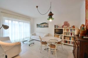 a living room with a table and chairs and a couch at Sofia by KlabHouse in Santa Margherita Ligure