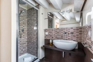 a bathroom with a sink and a shower at Modica for Family - Rooms and Apartments in Modica