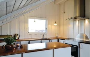 a kitchen with a wooden counter top and a window at Holiday Home Hvide Sande 20 in Bjerregård