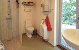 a bathroom with a toilet and a sink and a shower at Four-Bedroom Holiday Home In Stege in Stege