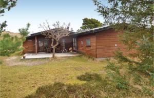 a wooden house with a yard in front of it at 4 Bedroom Stunning Home In Fan in Fanø
