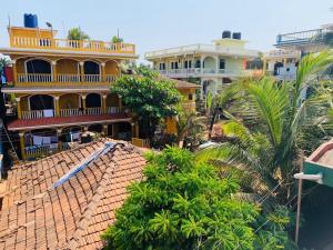 an aerial view of a building with palm trees at Rosy Guest House in Calangute