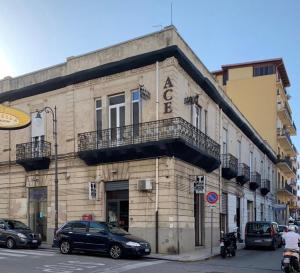 a building with cars parked in front of it at Ace Rooms VSG in Villa San Giovanni