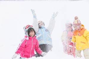 a group of people standing in the snow at Kyukamura Iwate-Amiharionsen in Shizukuishi