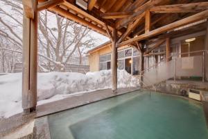 a swimming pool covered in snow in a building at Kyukamura Iwate-Amiharionsen in Shizukuishi