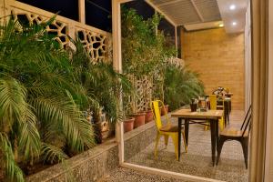 a patio with a table and chairs and plants at Hotel Sapphire in Chandīgarh