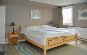 a bedroom with a bed and two lamps and a window at 2 Bedroom Lovely Home In Sunne in Sunne
