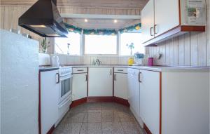 a kitchen with white appliances and a window at Holiday Home Søndervang Hejls in Hejls