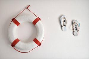 a life buoy and a pair of sandals on a table at Casa M&M in Cala Gonone