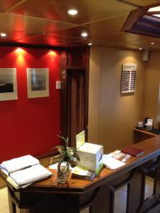 a desk in an office with a red wall at LES ARCADES in Dieppe