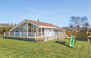 a small house with a porch and a yard at Holiday Home Søndervang Hejls in Hejls