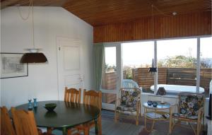 a living room with a table and chairs and a bedroom at Holiday Home Løgstør 53 in Løgstør