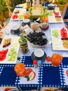 a long table with plates of food on it at Jemin Apartment in Berat