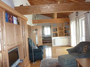 a living room with a couch and a tv at Ferienhaus Feist in Bodenmais