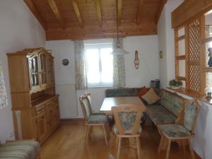 a living room with a couch and a table at Ferienhaus Feist in Bodenmais