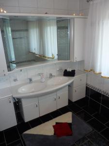 W łazience znajduje się biała umywalka i lustro. w obiekcie Ferienhaus Feist w mieście Bodenmais